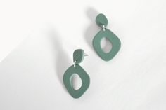 Sage Green Organic Shaped Statement Hoop Earrings handmade from polymer clay. Very lightweight and measures approximately 45mm (1.77 inches) long x 25mm (0.98 inches) at the widest part. Surgical steel ear posts. Available in silver or gold findings. Please, choose your favourite material before adding to the cart. Note that each earring in a pair will not be identical due to each one being individually handmade and therefore unique. Please bear in mind that photo may differ slightly from the actual item in terms of colour due to the lighting during photo shooting or the display characteristics of your electronic device. I have made every effort to display, as accurately as possible, the colours of my products that appear on the website. Care instructions Polymer Clay is strong but sensibl Minimalist Green Polymer Clay Earrings, Green Hoop Earrings, Contemporary Jewelry Design, Statement Hoop Earrings, Gift Ideas For Her, Earrings Simple, Earrings Minimalist, Baby Wipes, Simple Earrings