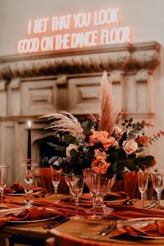 a table set with place settings and flowers