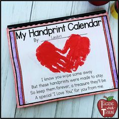 a valentine's day handprint calendar is displayed on a table