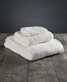 four white towels stacked on top of each other