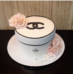 a chanel cake with pink roses and pearls