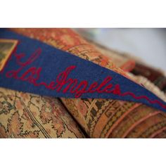 a blue ribbon with the word los angeles on it is laying on top of an old rug