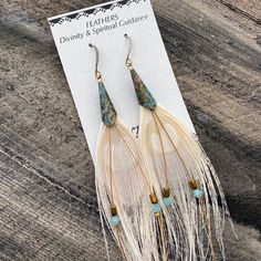 white peacock feather earrings > modern bride earrings > bohemian feather earrings > free spirit earrings > spiritual guidance earrings > peacock feather earrings These gorgeous white peacock feather earrings are perfect for a modern bohemian bride at their wedding, a free spirit, or anyone who appreciates feather jewelry. These beauties are made of peacock feathers, Swarovski crystals, hematite, and pierced french earring hooks, and measure approximately 3.5 to 4 inches in length Boho Feather Earrings, Crystals Hematite, Free Spirit Jewelry, Unique Wedding Accessories, Peacock Feather Earrings, Mom Earrings, Energy Jewelry, White Peacock, Native American Earrings