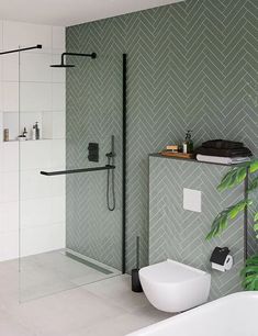 a modern bathroom with green herringbone wallpaper and white bathtub in the corner