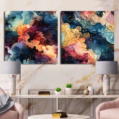 two paintings on the wall in a living room