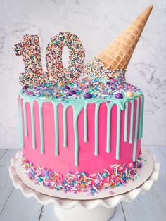 a birthday cake with sprinkles and ice cream on top that has the number ten on it