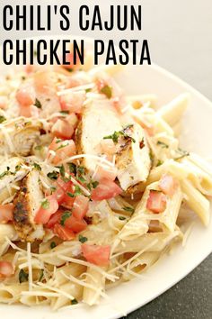 a white plate topped with pasta and chicken