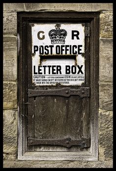 an old post office letter box on the side of a building