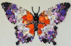 a butterfly made out of buttons and other items on a white surface with the words, button art written below it