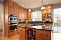 a kitchen with wooden cabinets and stainless steel appliances