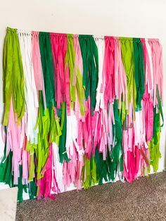 colorful streamers are hanging on the wall next to a carpeted area with a rug