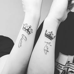 two people with matching tattoos on their arms, one has a crown and the other has a cat