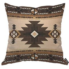 a brown and white pillow with an intricate design on the front, sitting on a white background