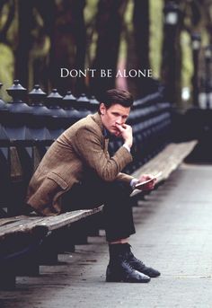 a man sitting on a bench reading a book