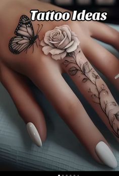 a woman's hand with tattoos and flowers on it