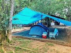 a tent set up in the middle of a forest