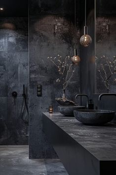 a black bathroom with two sinks and a shower