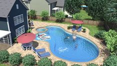 an aerial view of a backyard with a swimming pool and patio furniture set up around it