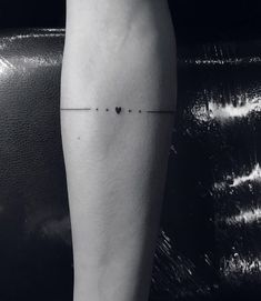 a black and white photo of a person's leg with a cross on it