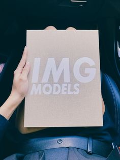 someone holding up a piece of paper with the word img models printed on it