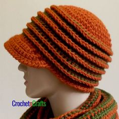 an orange and green knitted hat on top of a mannequin's head