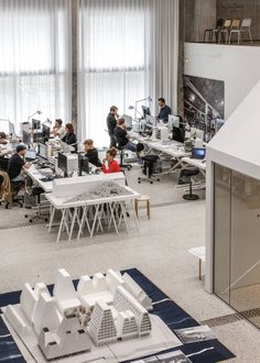 an office filled with people sitting at desks