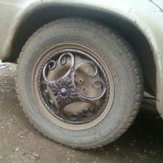 an old car tire with intricate designs on it's rim and the tires are dirty