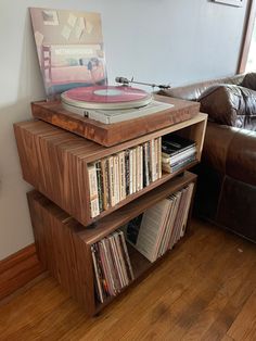 a record player sitting on top of a wooden shelf