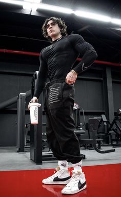 a man standing on top of a red floor