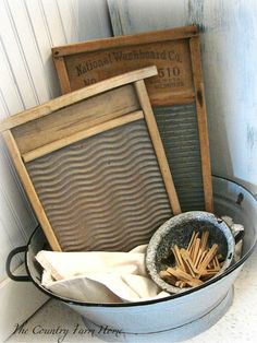 a bucket filled with wooden sticks next to an old sign and some other items in it