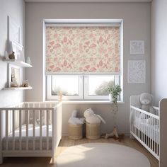 a baby's room with a white crib and pink floral roller shades in the window