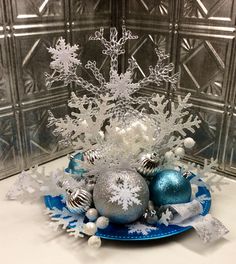 a blue plate with silver and white ornaments on it