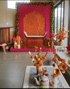 a decorated stage set up with flowers and teapots