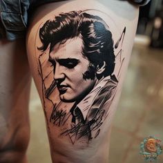 a man's thigh with a portrait of elvis presley in black and grey ink