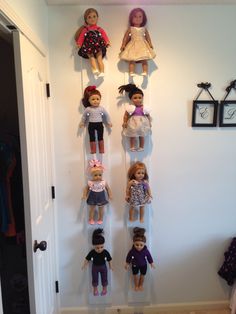 a group of dolls hanging on the wall