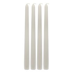 four white candles sitting on top of each other