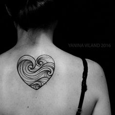 a woman with a heart tattoo on her back