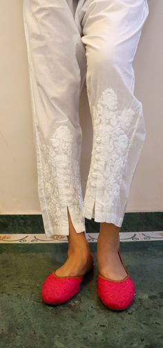 Relaxed Fit Cotton Pants with opening and button inserts. Embroidered in chikankari by skilled artisans. Length - 38/39 inches Size -  S -  waist stretched fits upto 40 M - waist stretched fits upto 42 L -  waist stretched fits upto 44 XL - waist stretched fits upto 46 XXL - waist stretched fits upto 48/50 Traditional White Bottoms, Traditional White Long Pants, Traditional Fitted Full-length Pants, Fitted Full-length Traditional Pants, Traditional White Trousers, Straight Pants With Chikankari Embroidery For Festive Occasions, Traditional White Straight Pants, White Bottoms With Chikankari Embroidery, White Cotton Pants With Resham Embroidery