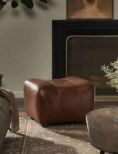 a living room filled with furniture and a fire place next to a painting on the wall