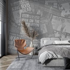 a bed room with a neatly made bed and a chair next to a window that has newspaper coverings on it