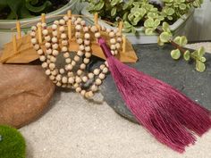 Hand carved, traditional Tulsi beads from the Vrindavan area of India, hand-knotted on a Ruby Red Yarn and closed off with a beaded tassel Tulsi or Holy Basil is the most sacred plant in Hinduism, but has also played a role in Christianity. Closely intertwined with Lakshmi and Krishna. It is believed to nurture devotion and love, and bring about luck, prosperity, abundance and wealth. It is also the symbol of Motherhood. Among its many properties, Tulsi is associated with: * Devotion and Faith * Natural Hand-strung Beaded Necklace As A Gift, Natural Beaded Necklace As Gift, Hand-strung Natural Beaded Necklace For Gift, Hand-strung Natural Beaded Necklaces For Gifts, Hand-strung Natural Beaded Necklaces As Gifts, Tulsi Mala Design, Adjustable Spiritual Mala For Puja, Adjustable Hand-strung Mala For Puja, Tulsi Mala