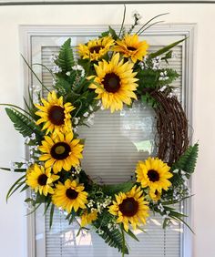 a wreath with sunflowers on the front door