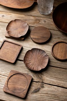 wooden plates and trays are arranged on a table