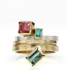 D E T A I L S :Tourmaline Geometric ring, One of a Kind stacking ringGemstones: 1.19 ct Salmon pink tourmalineMetal: Sterling Silver and 14k solid yellow goldBand Width: 2mmSize: 6.5 USOne of a kind Art JewelryHandmade by Jen Volkodav in the USA ______________ FINE JEWELRY THAT IS ONE OF A KIND - JUST LIKE YOU: This is a very cool geometric sterling and 14K ring design with an amazing Brazilian tourmaline! Fresh off the bench. The modified square cut tourmaline weighs 1.19 carats and has a beaut Modern Tourmaline Emerald Ring, Stackable Tourmaline Rings In Fine Jewelry Style, Stackable Tourmaline Rings Fine Jewelry, Yellow Gold Gemstone Rings, Paraiba Tourmaline Ring, Pink Tourmaline Ring, Paraiba Tourmaline, Handmade Fine Jewelry, Geometric Ring