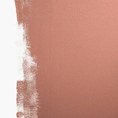 the wall is painted pink and white with some brown paint on it's side