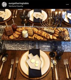 a table set with silverware, plates and utensils for dinner or dessert