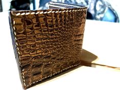 One of a kind embossed gator bi fold wallet. 100% sewn and assembled by hand. Even have the calluses to prove it. Is it the best wallet ever made?? No. Is it the prettiest? Once again that would be no. What it is tho is a unique one of a kind item made by me, patiently waiting to send it off to its new home where it will be used for many years to come. Made with high quality leather to withstand many years of being over stuffed, sat on, tossed around and maybe chewed on by critters and youngster Embossed Brown Wallets As Gift, Leather Wallet With Crocodile Pattern, Luxury Handmade Wallets For Gifts, Bifold Wallet With Crocodile Pattern For Gift, Bifold Wallet With Crocodile Pattern As Gift, Embossed Rectangular Wallets For Gifts, Crocodile Pattern Bifold Wallet As A Gift, Handmade Bifold Wallet For Formal Occasions, Handmade Brown Wallet For Formal Occasions