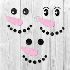 a snowman made out of black and pink paper on a white wooden background with polka dots