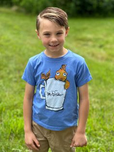 This light blue t-shirt features a Little Plastic Castle-inspired goldfish design. The back is printed with a castle and babe logo. 52% cotton / 48% Polyester Origin: USA Goldfish Design, Light Blue T Shirt, A Castle, Blue T Shirt, Blue Tshirt, Goldfish, The Back, Baby Clothes, Castle