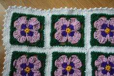 crocheted squares with purple and green flowers on them